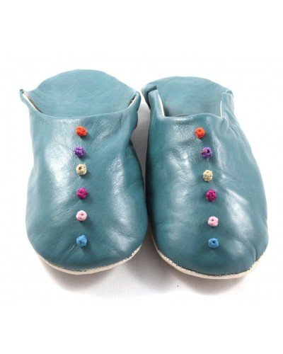 Pom-pom slippers in turquoise leather